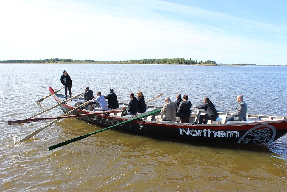 A group of people are in a boat that says northern