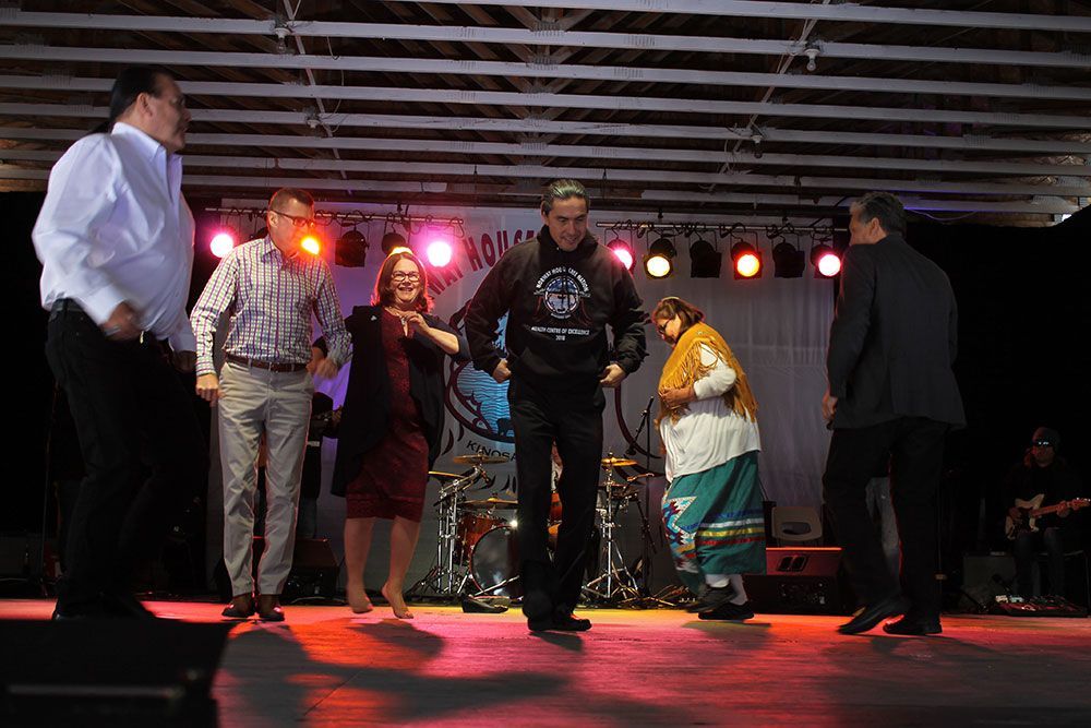 A group of people are dancing on a stage.