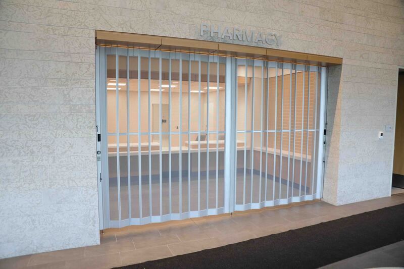 An empty pharmacy with a sliding glass door
