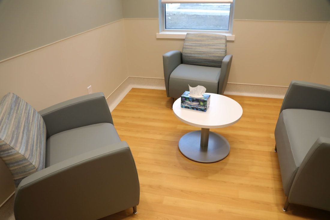 There are two chairs and a table in the room.