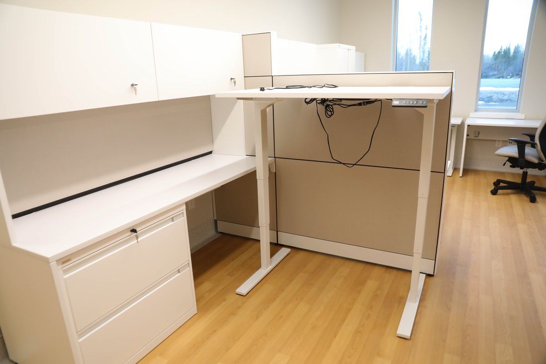 There is a standing desk in the middle of the room.