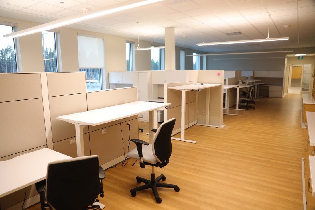 A large office with a lot of desks and chairs