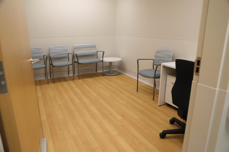 A waiting room with chairs and a desk