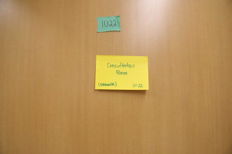 A yellow sticky note on a wooden door says cancelled