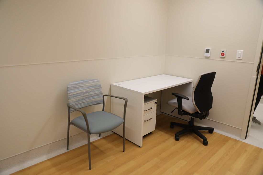 There is a chair and a desk in the room.