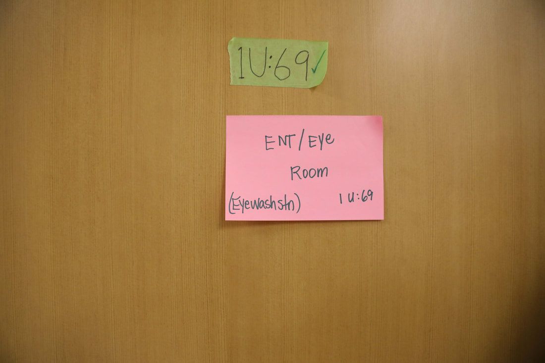 A pink sticky note on a door that says entire room