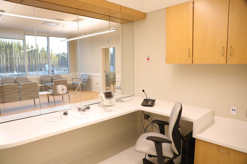 There is a desk with a microphone on it in the middle of the room.