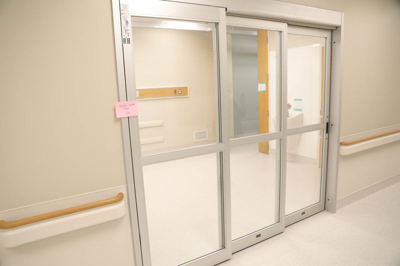 A hospital room with a sliding glass door.
