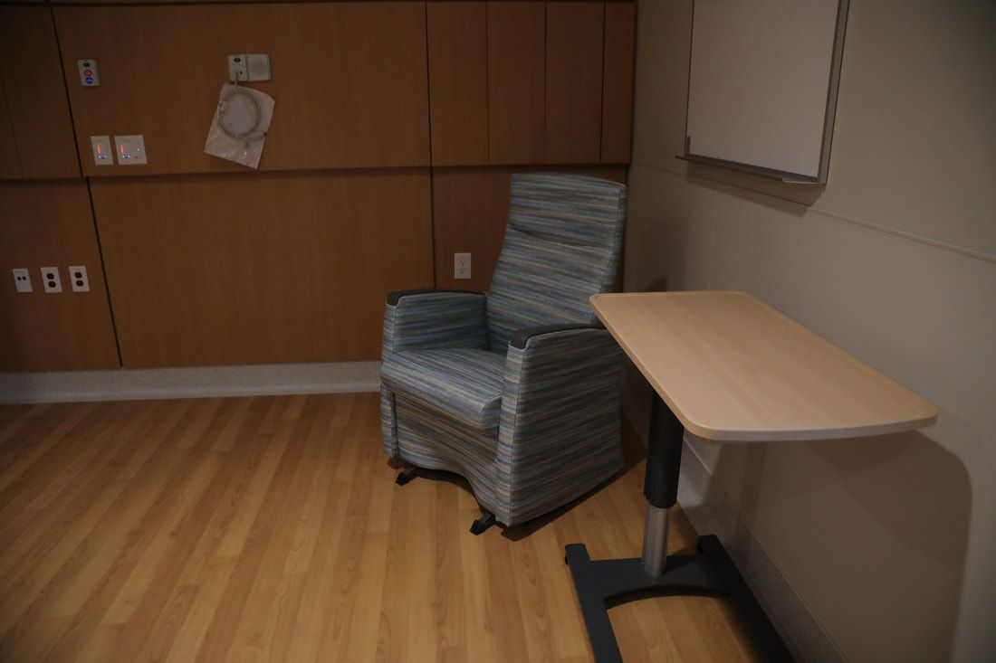 A chair is sitting in a room next to a table.