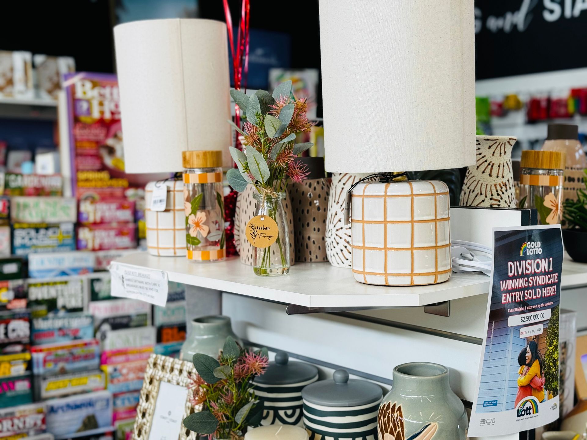 A Shelf Filled With Blue And White Ceramics In A Store — Yeppoon Central Lotto & News in Yeppoon, QLD