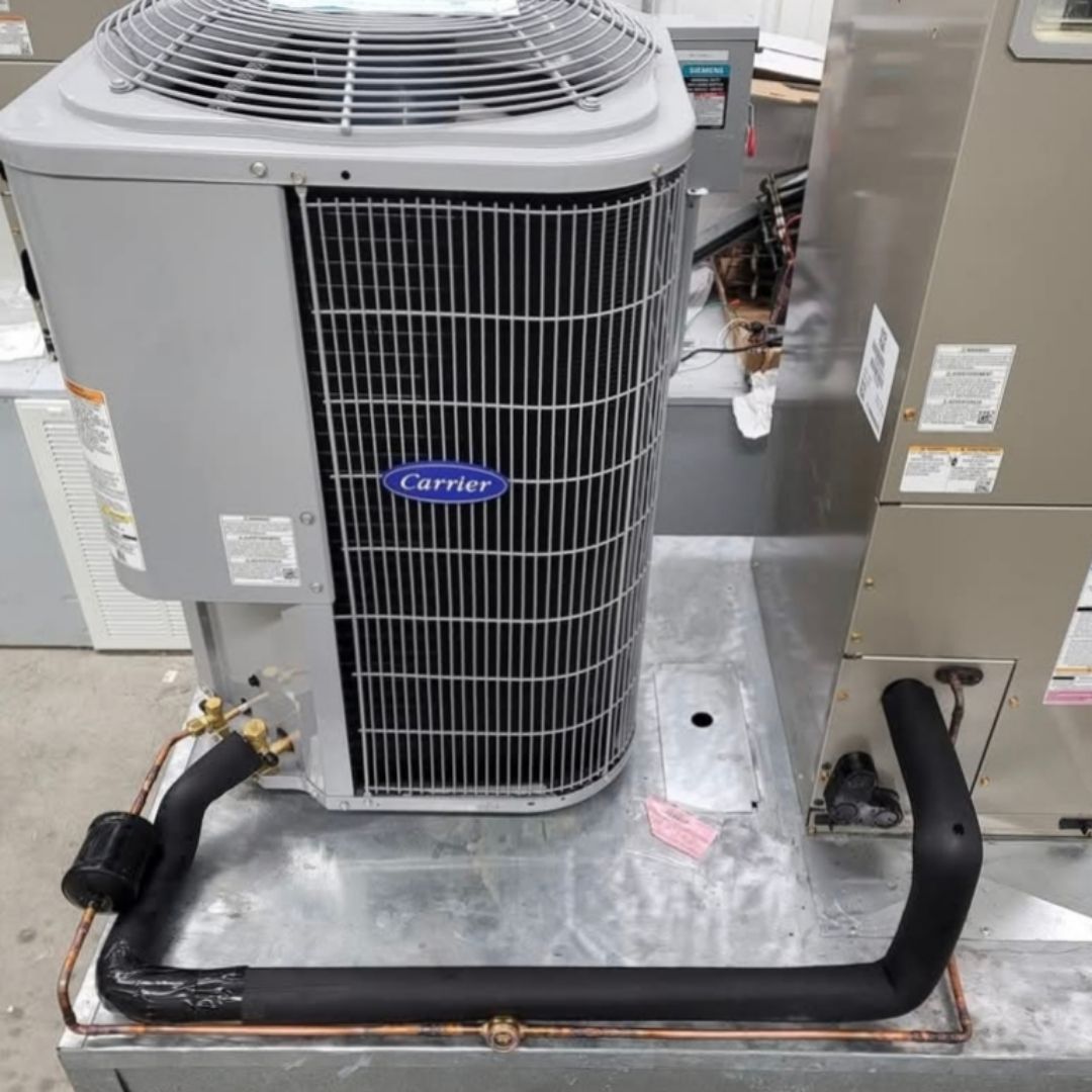 A carrier air conditioner is sitting on top of a metal shelf.