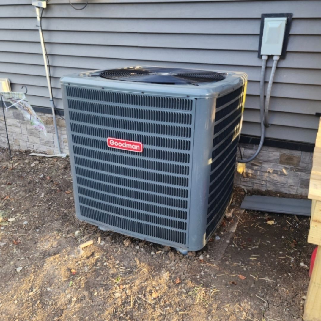 A dodge air conditioner is sitting outside of a house
