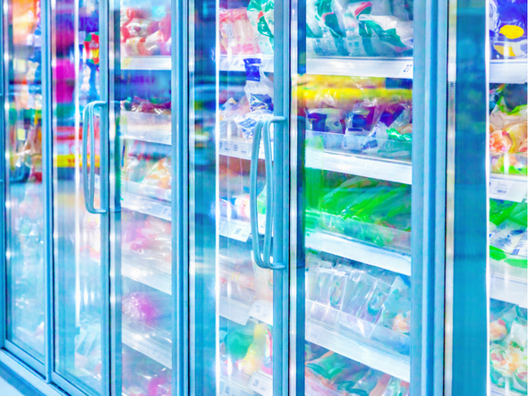 A refrigerator in a supermarket filled with lots of food and drinks.