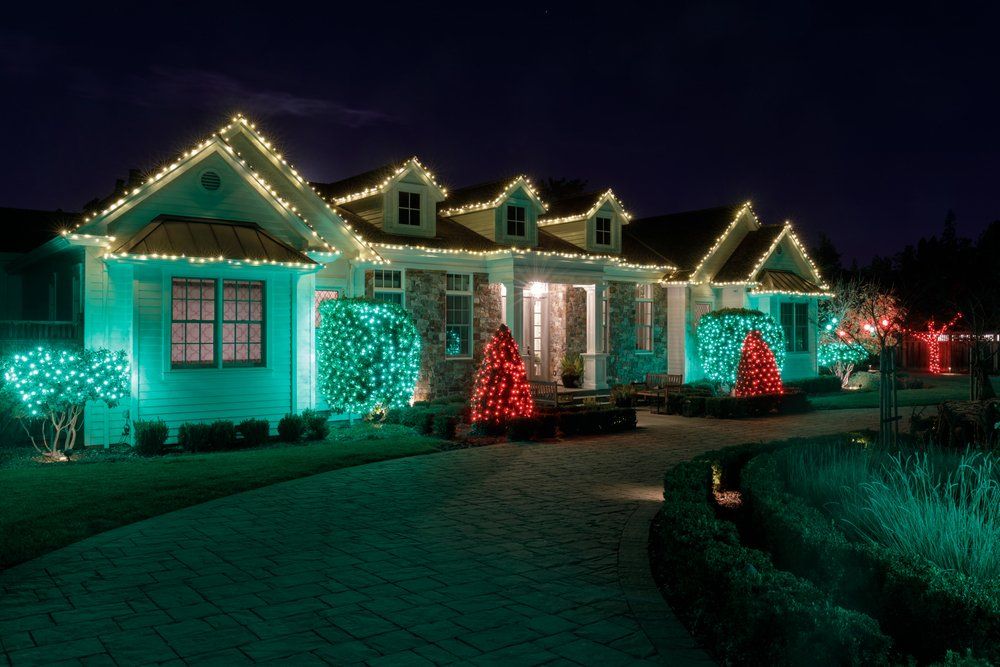 A home displays a variety of Christmas lights in the evening.
