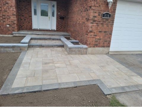 Brick house with paved entrance, steps, and front patio.