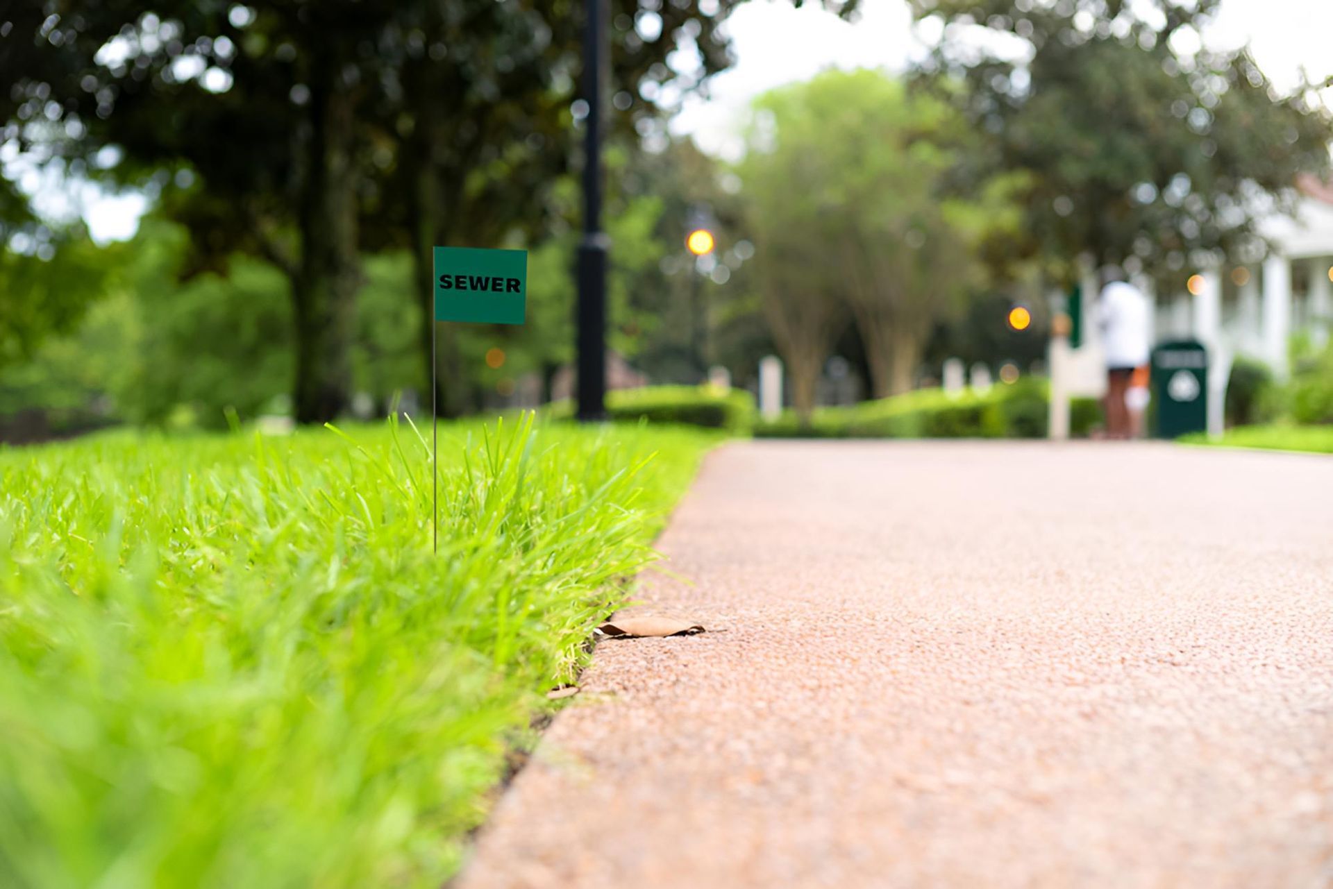 A Green Sign on the Side of a Path in a Park — Porta-Vac in Proserpine, QLD
