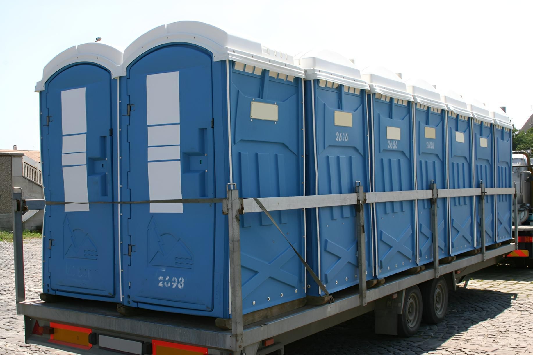 A Row of Blue Portable Toilets on a Trailer — Porta-Vac in Bowen, QLD