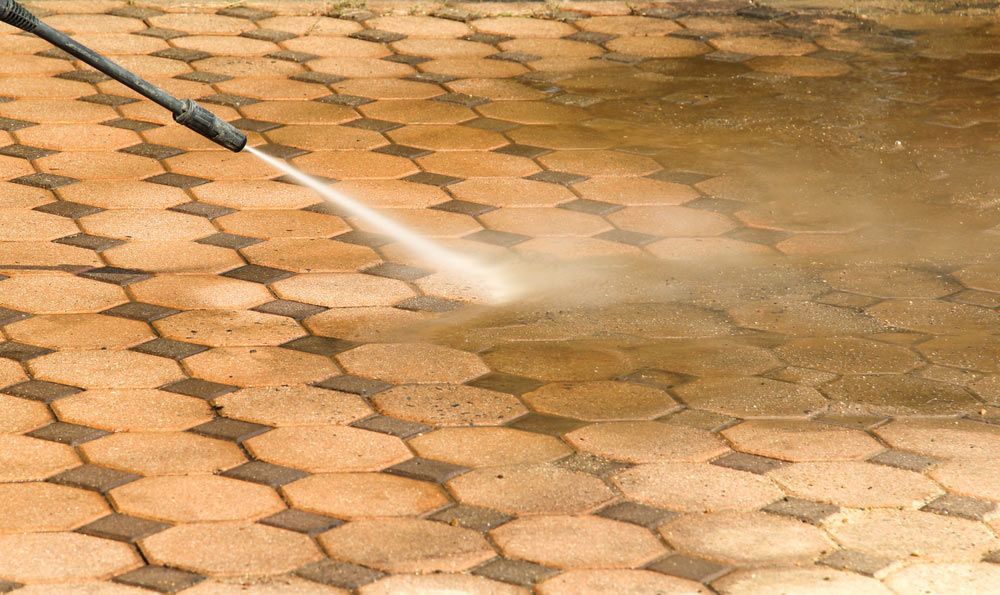 Using A High-pressure Water Jet To Clean A Concrete Block Floor — Porta-Vac in Proserpine, QLD
