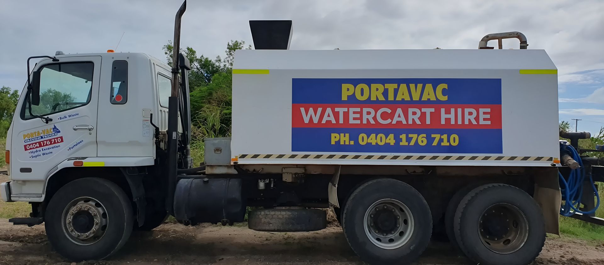A Portavac Water Cart Hire Truck Is Parked In The Dirt — Porta-Vac in Moranbah, QLD