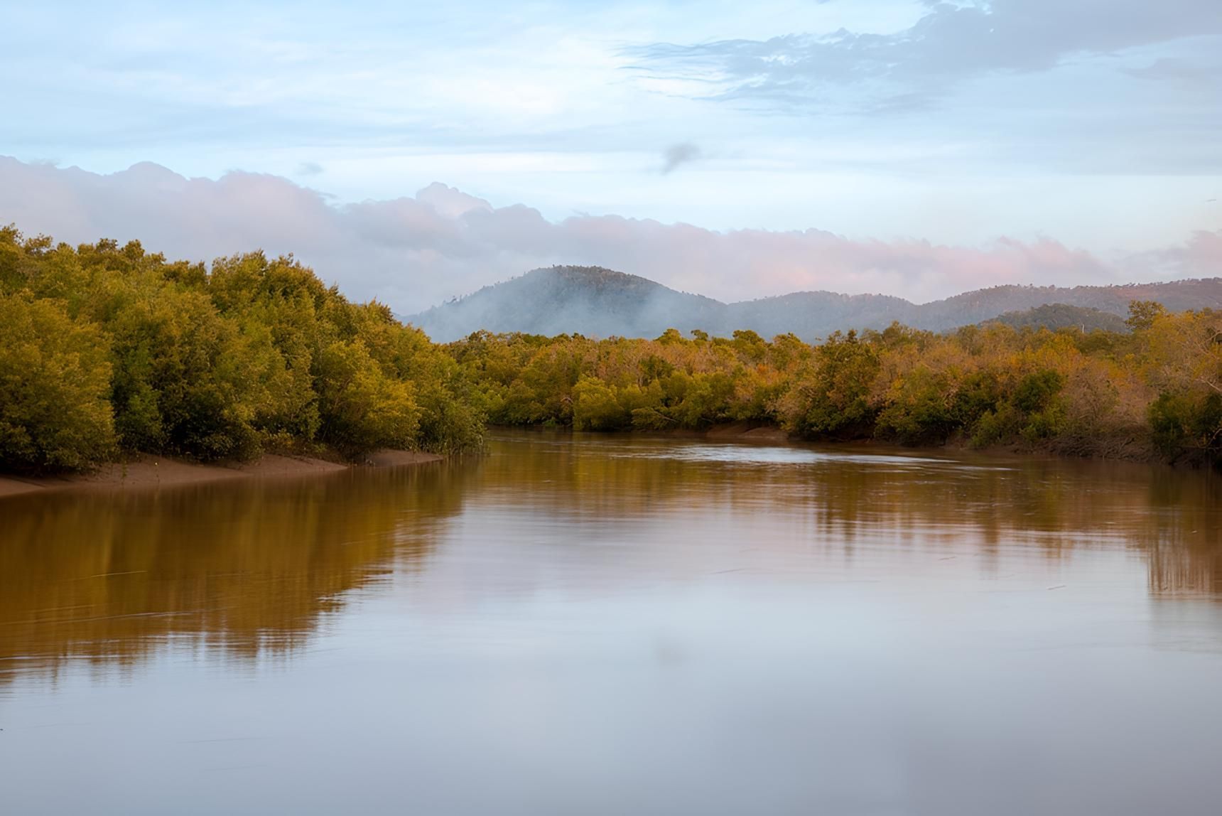 A River With Trees On The Shore And Mountains In The Background — Porta-Vac in Proserpine, QLD