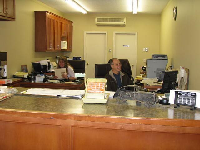 Man sitting at a desk - Auto body shop in Springfield, MA
