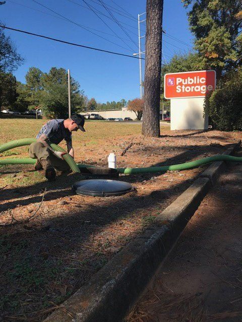 Man Fixing The Hose Four — Statham, GA — Affordable Septic Service