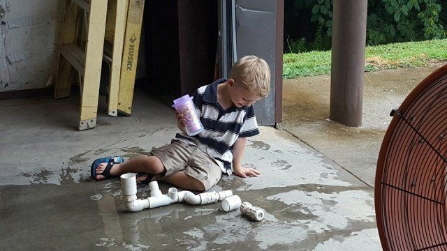 A Kid With A Bottle Of Water And Pipes — Statham, GA — Affordable Septic Service