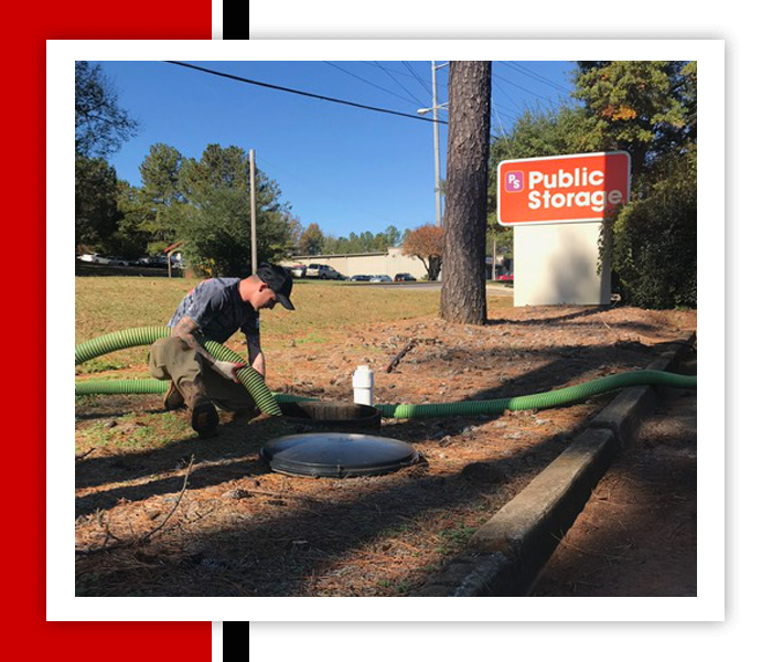 Man Putting A Hose In The Sewer — Statham, GA — Affordable Septic Service