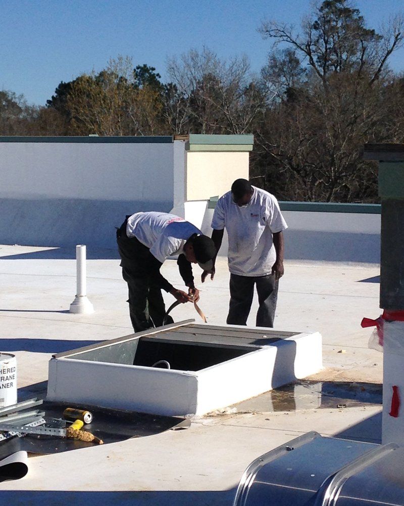 Workers On The Rooftop — Raymond, MS — Mid Mississippi Heating & AC, LLC