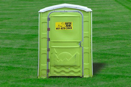 green handicap portable restroom on grassfield