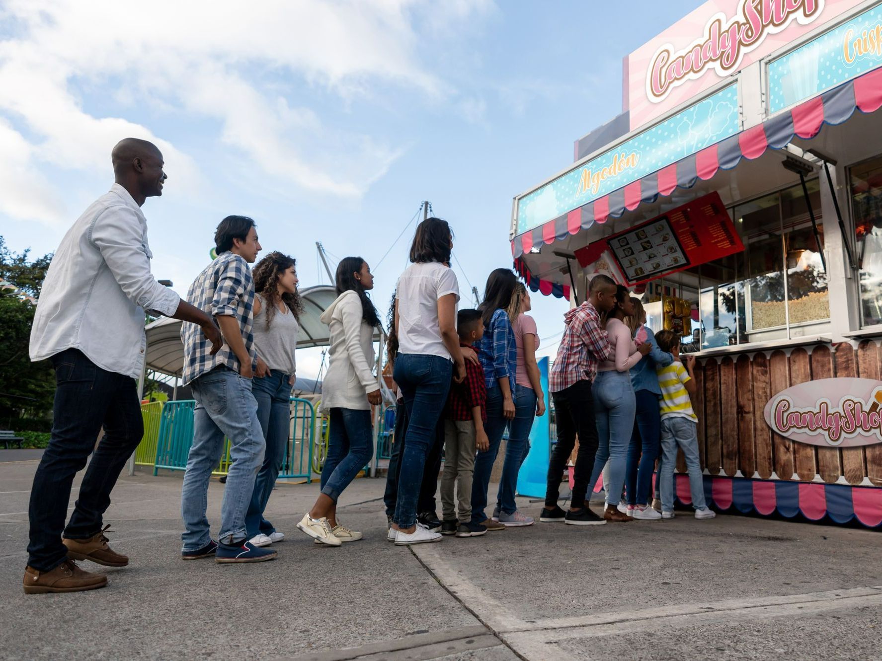 A group of people are standing in line at a food stand at a carnival. — Meridian, MS — Gotta Go Site Service Rentals