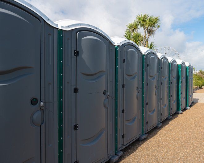 Row of Green Plastic Portable Toilets — North Jackson, MS — Gotta Go Site Service Rentals