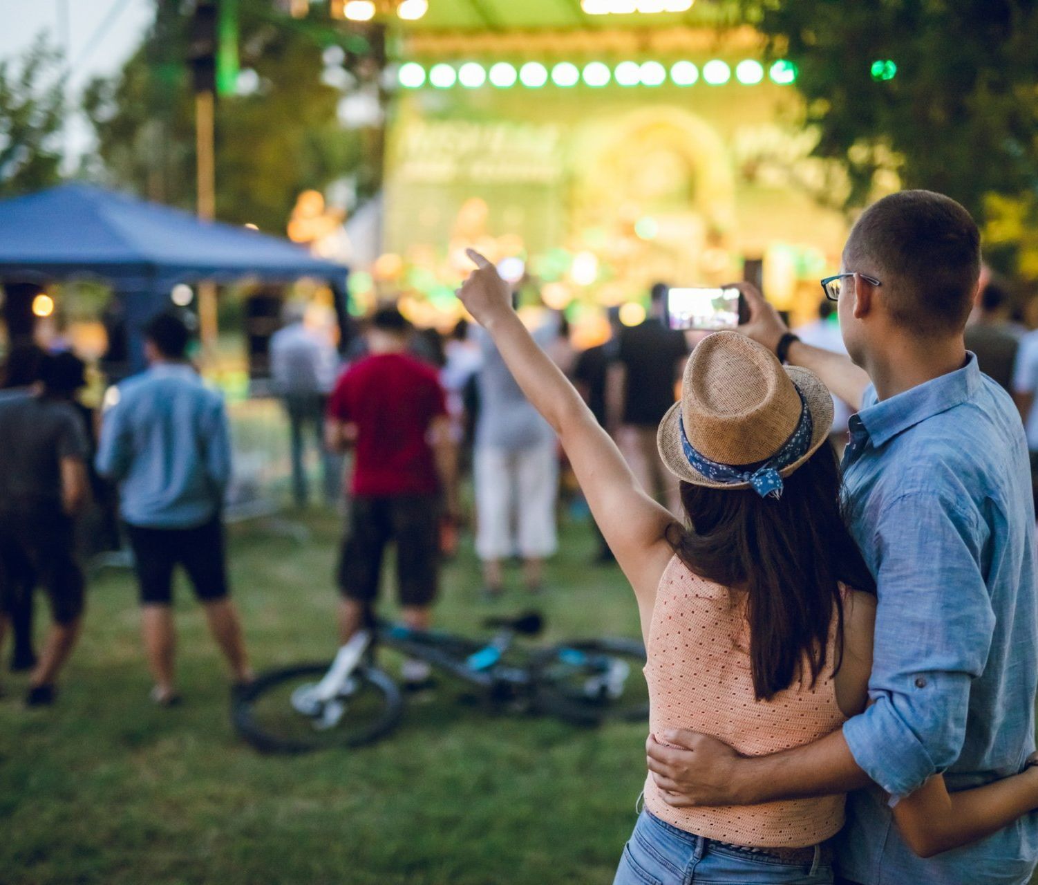 A man and a woman are taking a picture of a crowd at a concert. — Greenwood, MS — Gotta Go Site Service Rentals