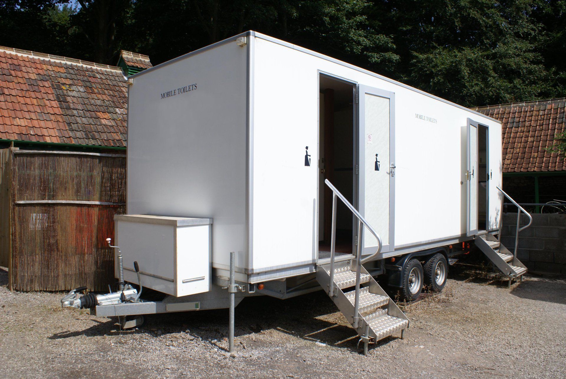 A white trailer with stairs leading up to it A white trailer with stairs leading up to it