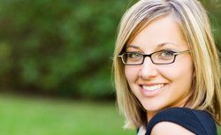 Eye Exams — Pretty Young Woman with Her New Eyeglasses in Hutchinson, KS