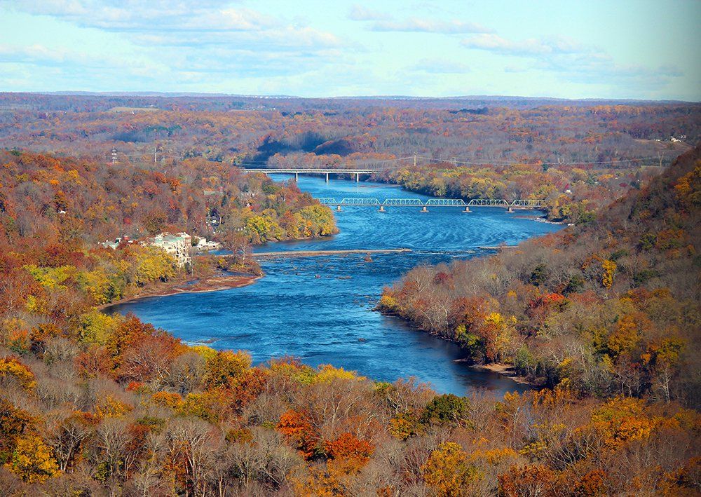 A view of the Lower Delaware River looking upstream to views of the New Hope wing dam and New Hope-Lambertville bridge.
