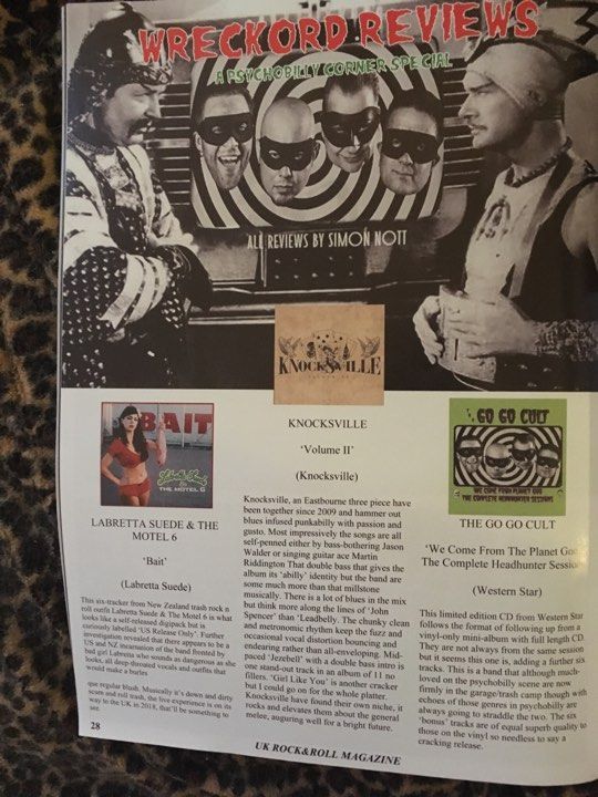 A magazine is open to a page that says ' records reviews ' on it