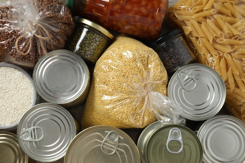 A variety of canned food including pasta and beans