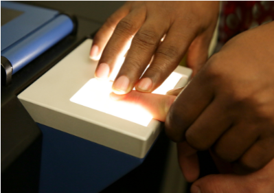 A person 's finger is being scanned by a machine