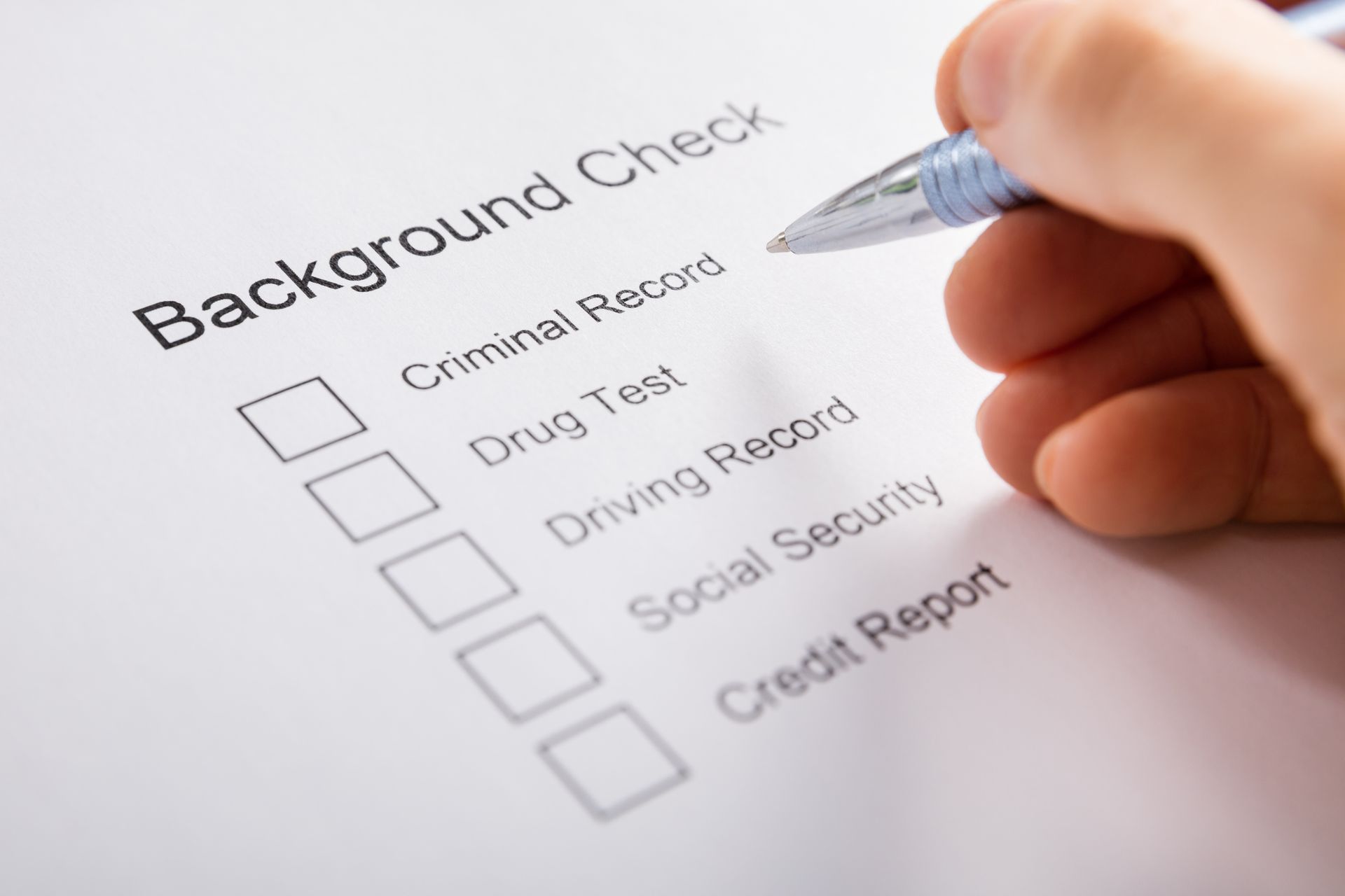 A person is filling out a background check form