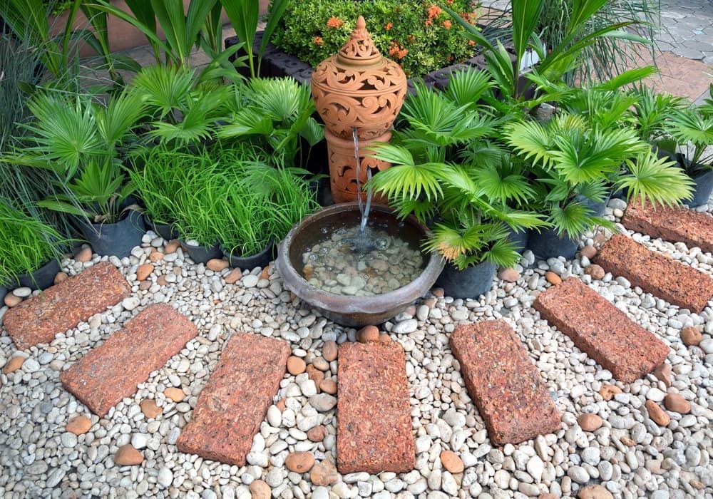 A Fountain In The Middle Of The Garden Surrounded — Baker & Co. Landscape Construction In Gulliver, QLD