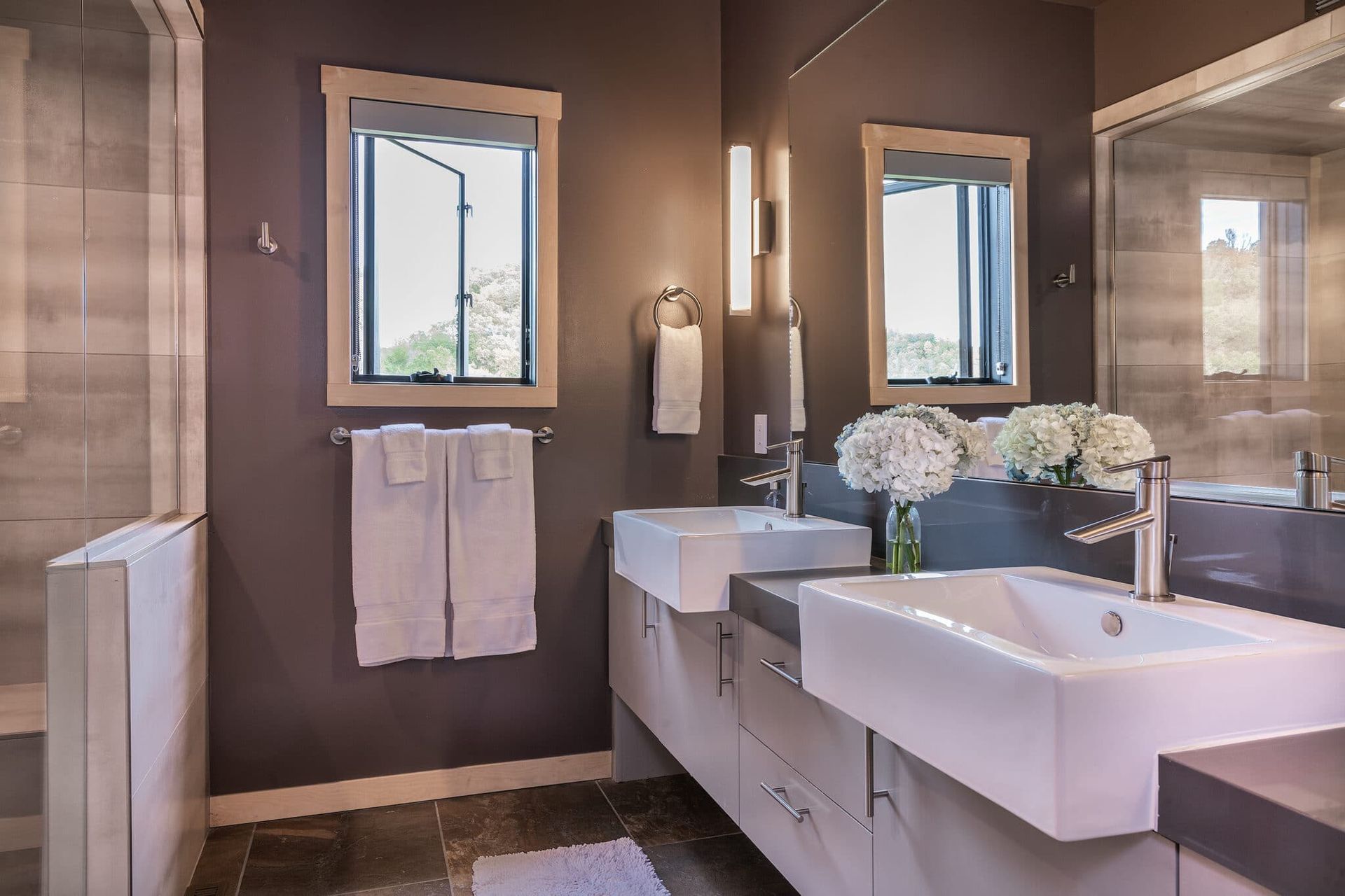 A bathroom with two sinks and two mirrors.