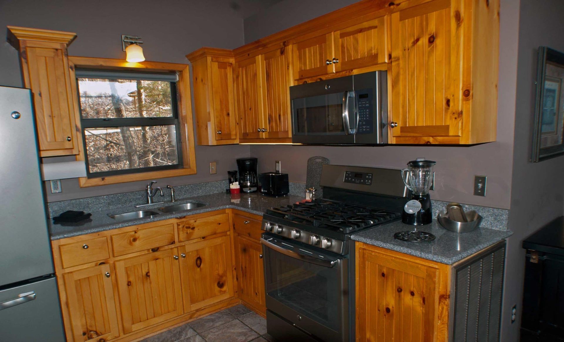 A kitchen with wooden cabinets and stainless steel appliances.