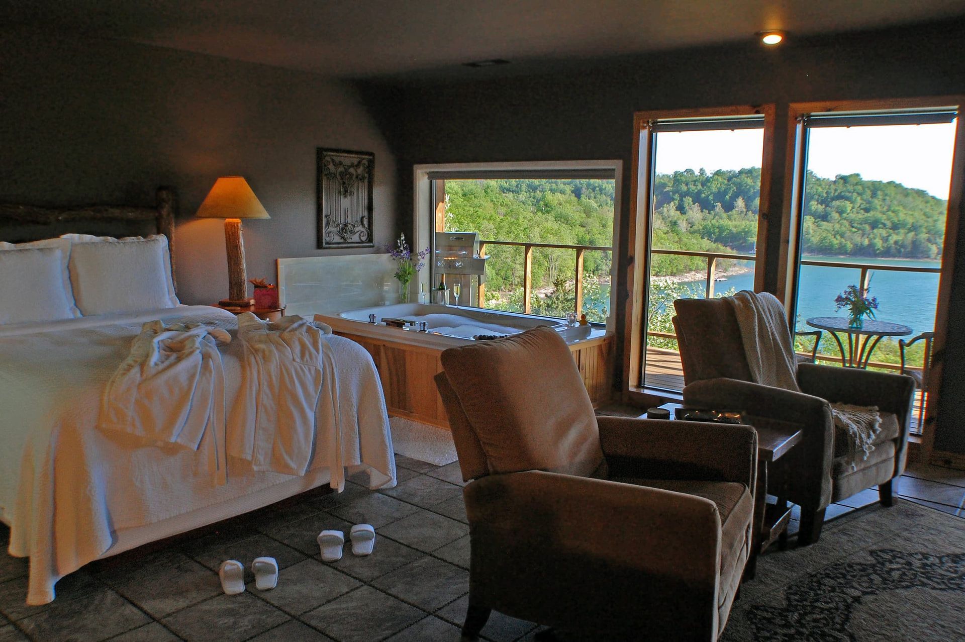 A hotel room with a large bed and chairs