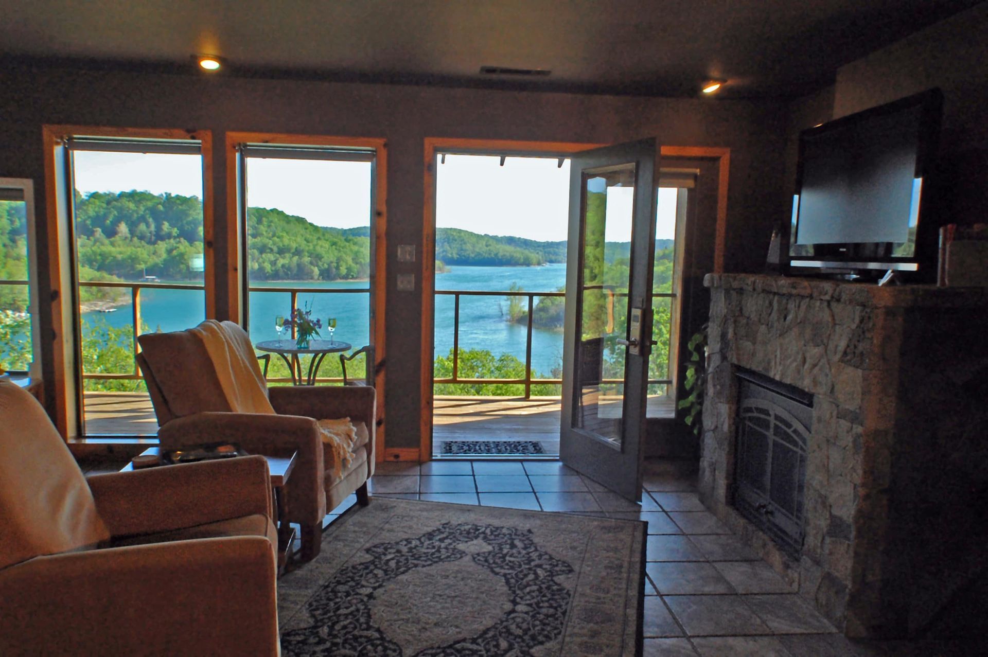 A living room with a fireplace and a view of a lake