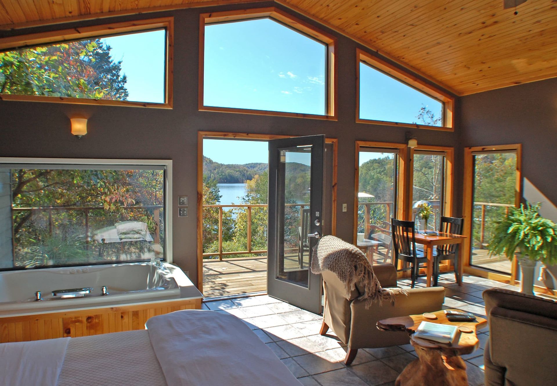 A living room with a large window and a jacuzzi tub