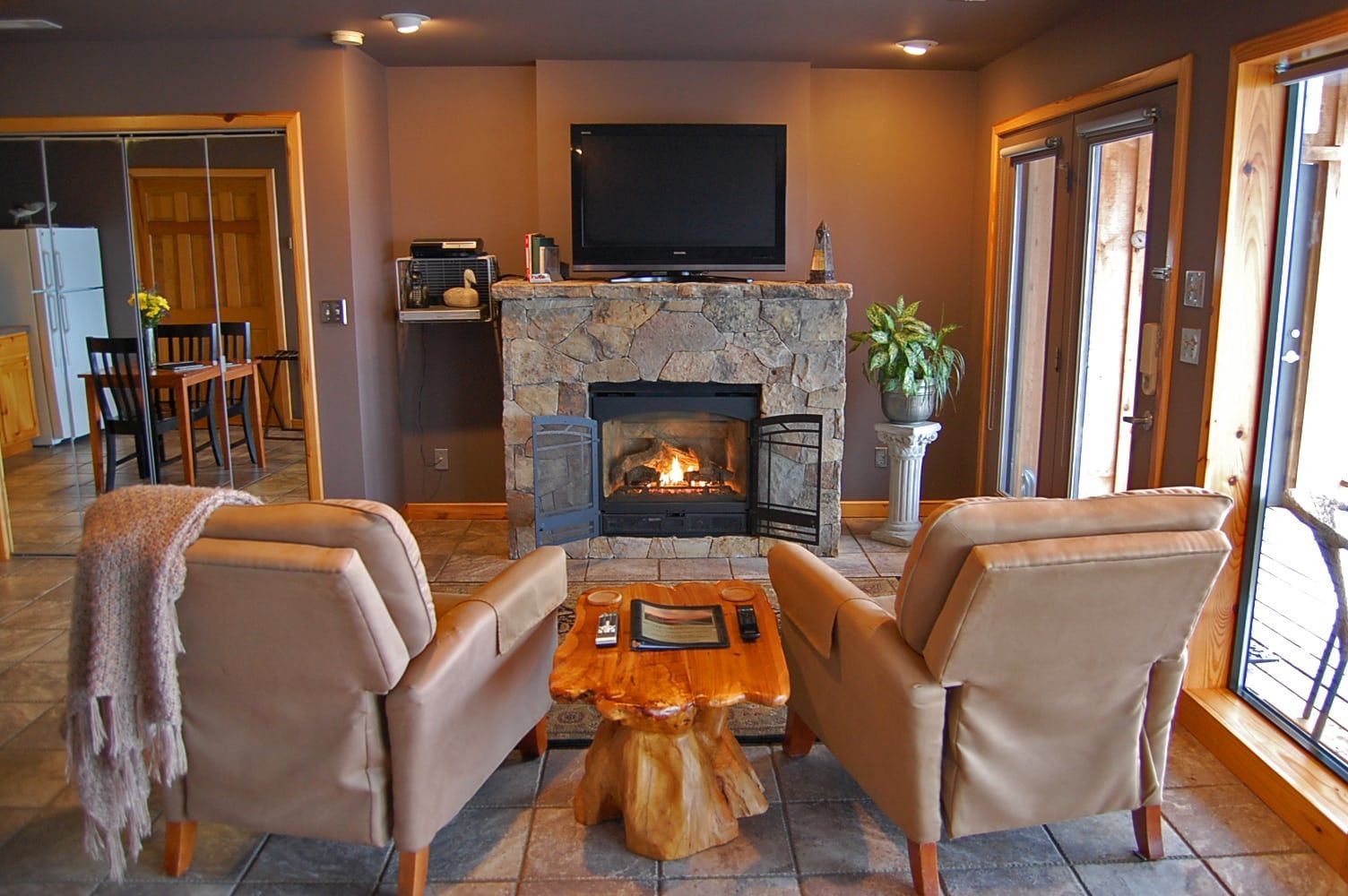 A living room with a fireplace and a flat screen tv