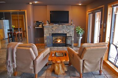 A living room with a fireplace and a flat screen tv
