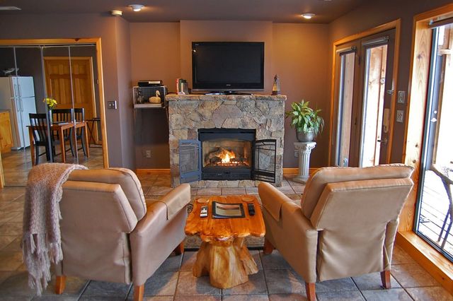A living room with a fireplace and a flat screen tv