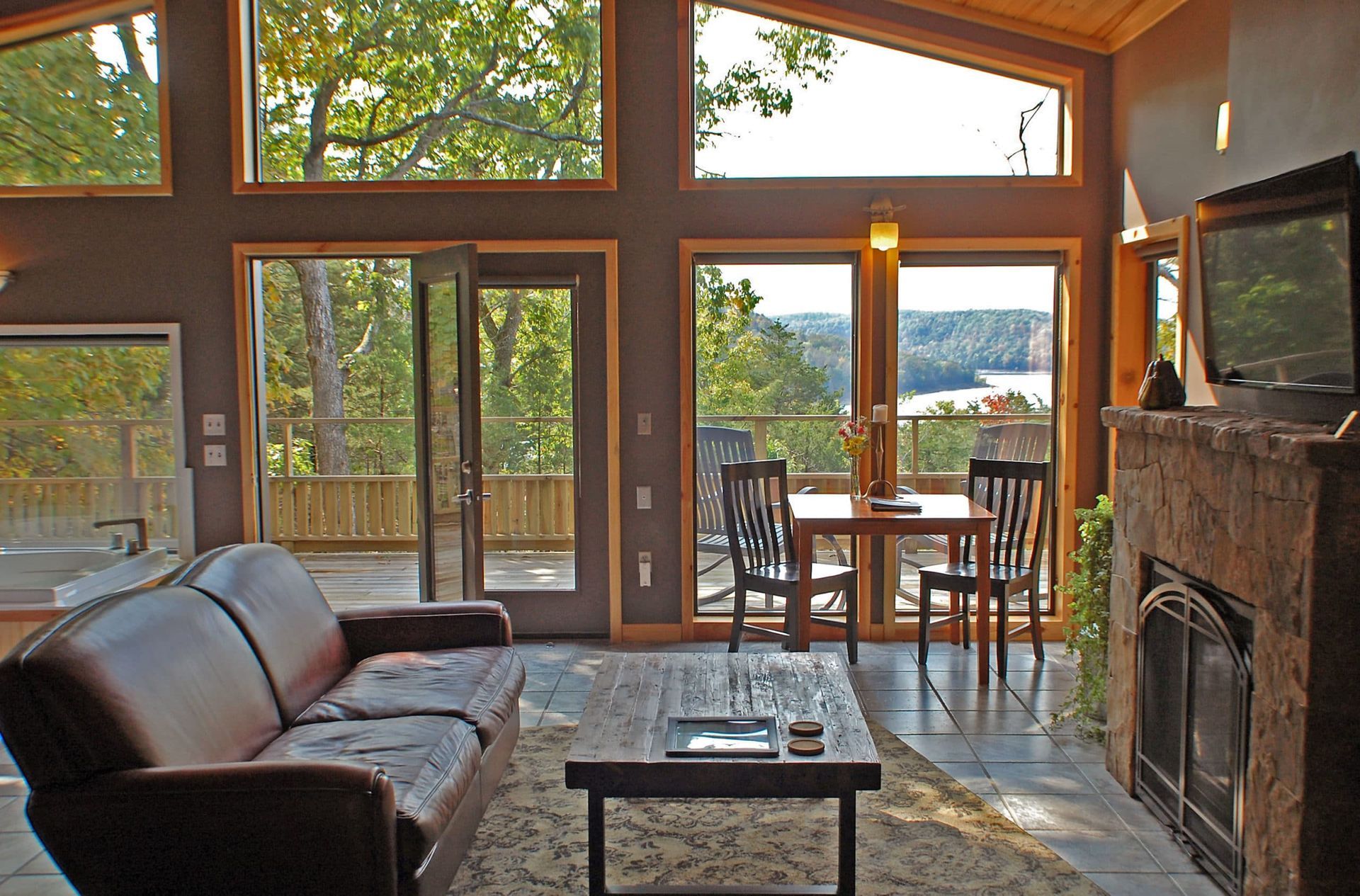 A living room with a couch a table and a fireplace